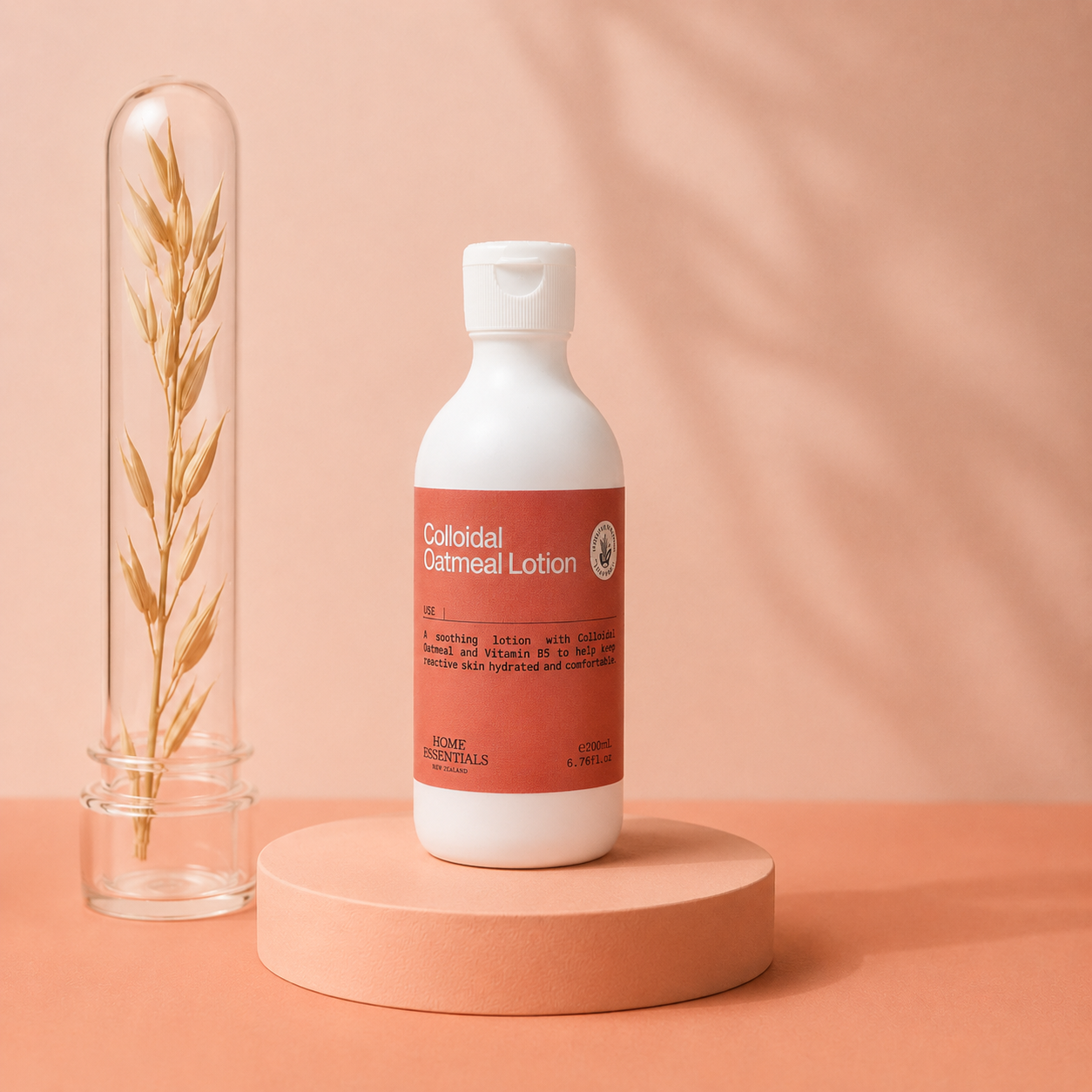 Colloidal Oatmeal Lotion on a pedestal, next to oat on coral background