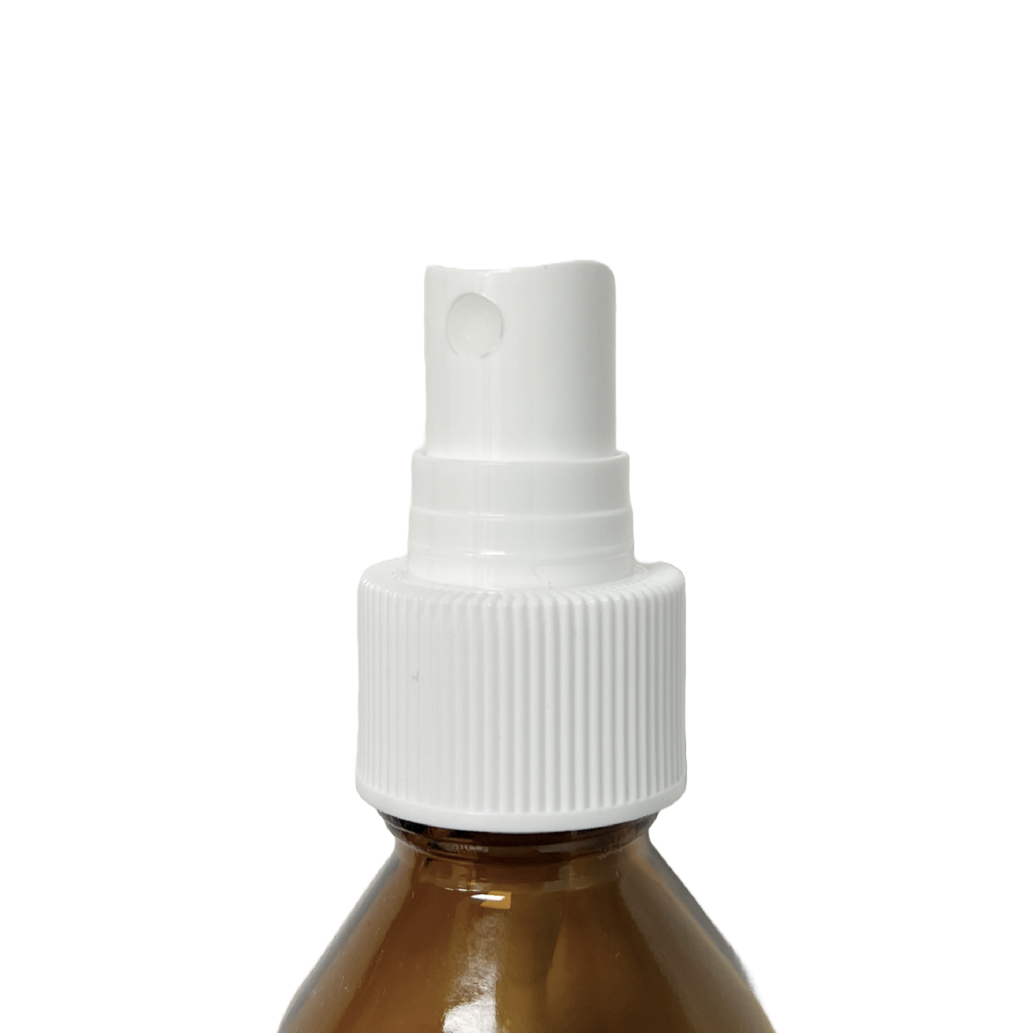 Home Essentials mist pump head fitted onto an amber glass bottle, showing the spray nozzle and ribbed screw cap in use.
