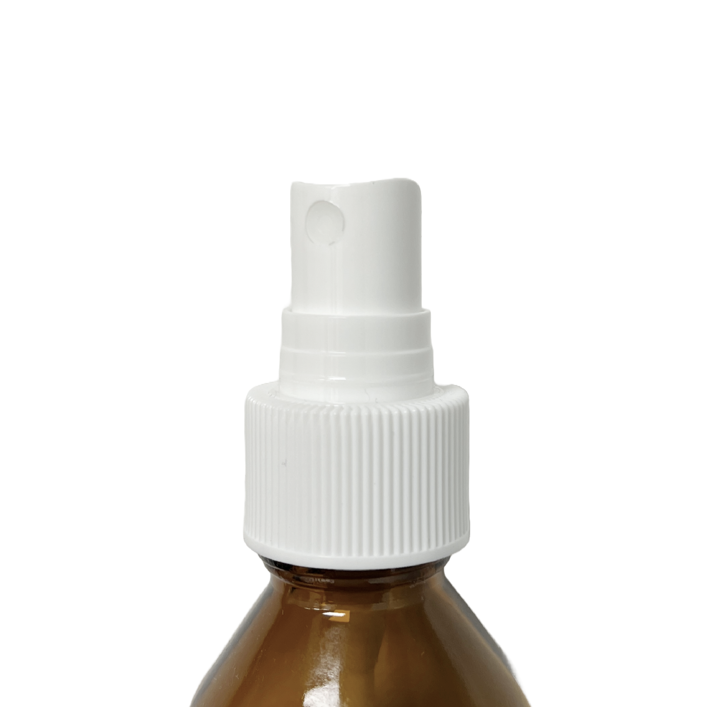 Home Essentials mist pump head fitted onto an amber glass bottle, showing the spray nozzle and ribbed screw cap in use.